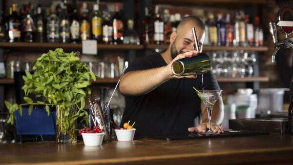 close-up-bartender-creating-delicious-drink